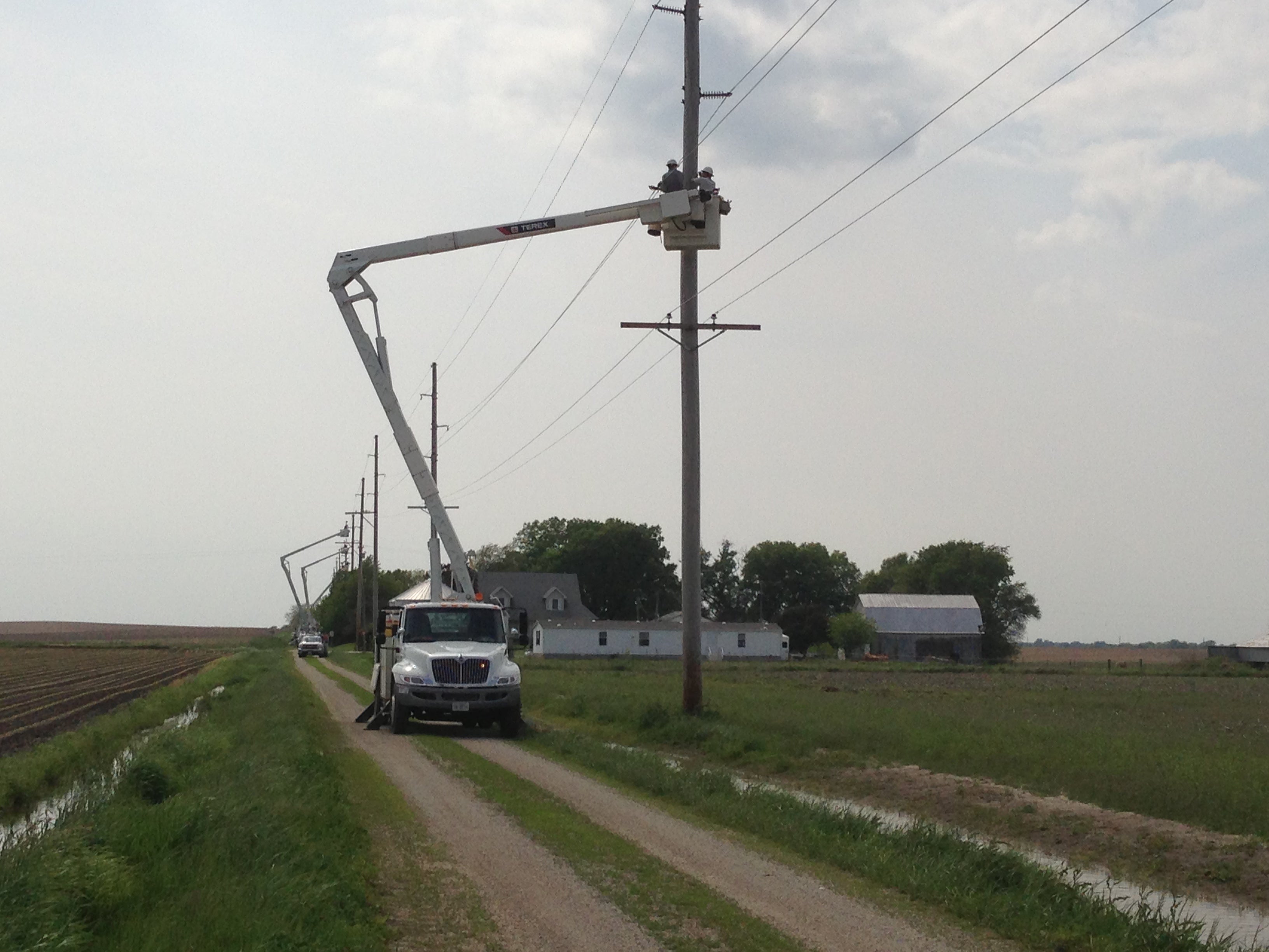 crews working on fixing a pole