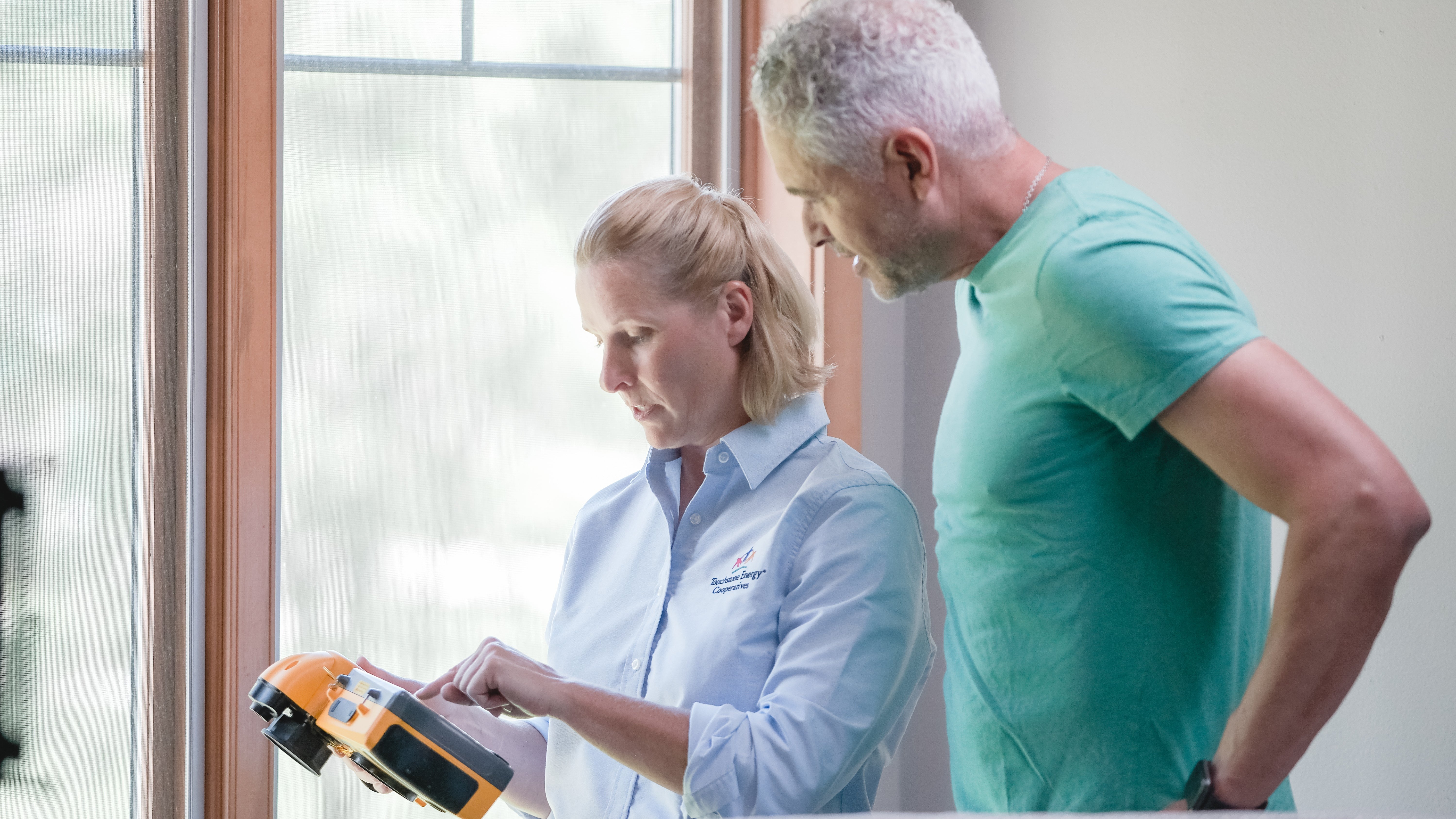 man and woman performing home energy assessment